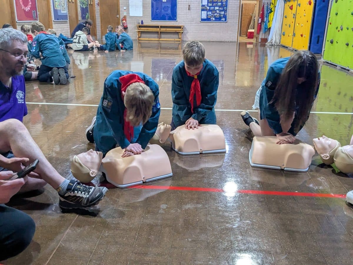 Scouts practising CPR on training manikins