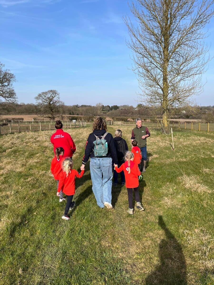 Squirrels and leaders walking together across a farm field